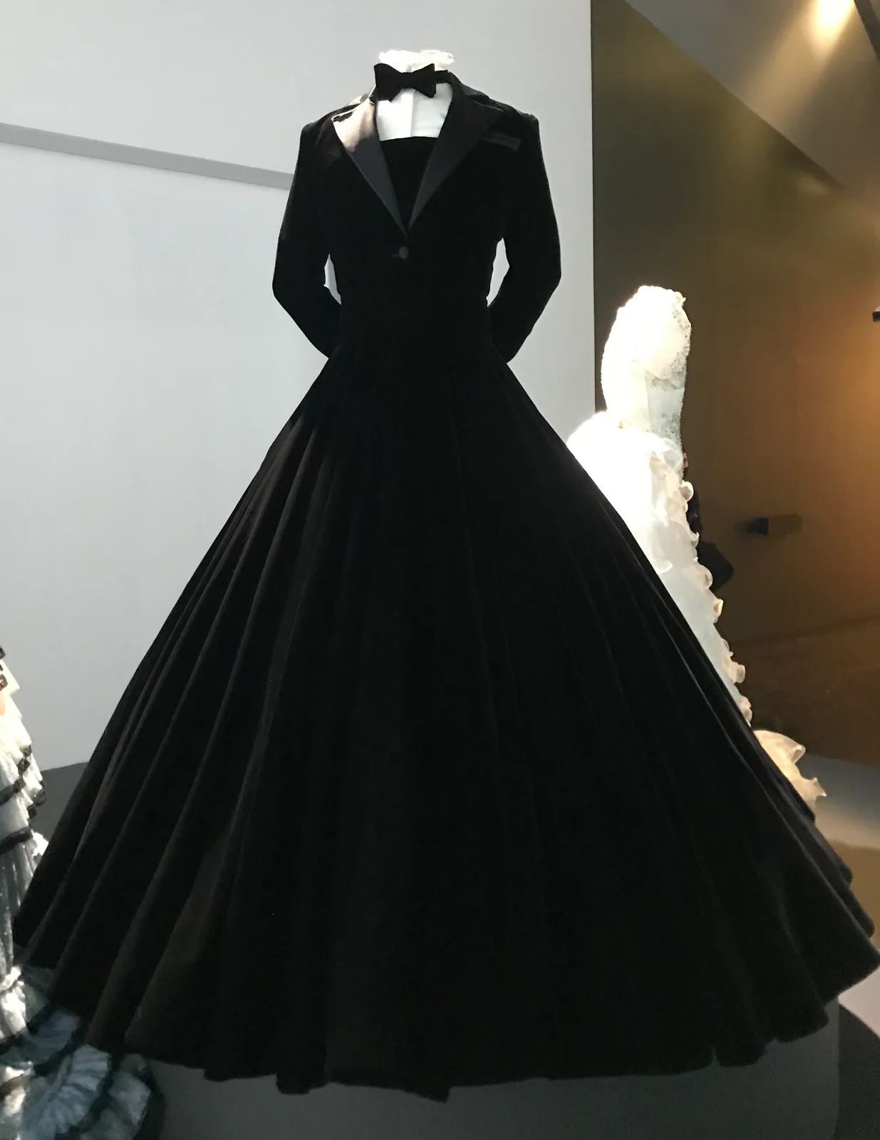 Black velvet tuxedo-styled dress worn by American actor Billy Porter on the red carpet of the 91st Academy Awards on February 24, 2019. Designed by Christian Siriano. Pictured here at Fashioning…