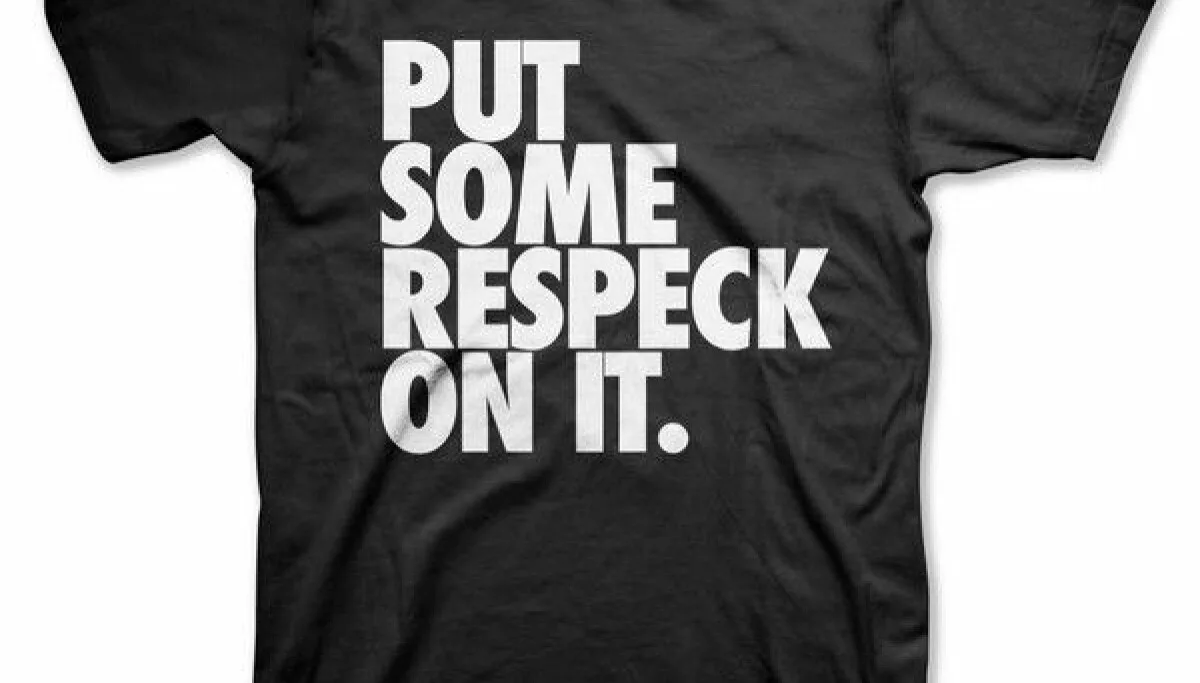 Okayplayer’s black T-shirt with “Put Some Respeck On It” printed in white.