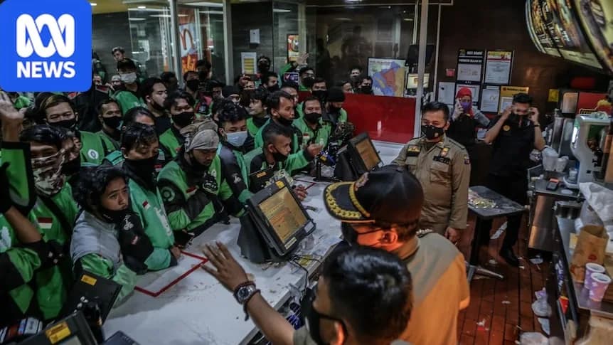 Dozens of food delivery riders queue up at a McDonald’s outlet in Bogor, Indonesia.