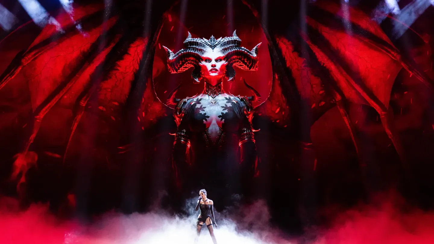 Halsey on stage in front of an image of Lilith from the Diablo franchise.