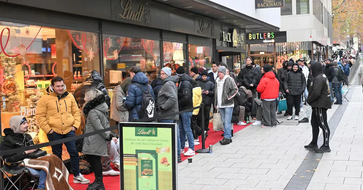 Customers line-up in front of a branch of chocolate producer Lindt before the sale of 100 Dubai Chocolate bars starts in Stuttgart, Germany. AFP