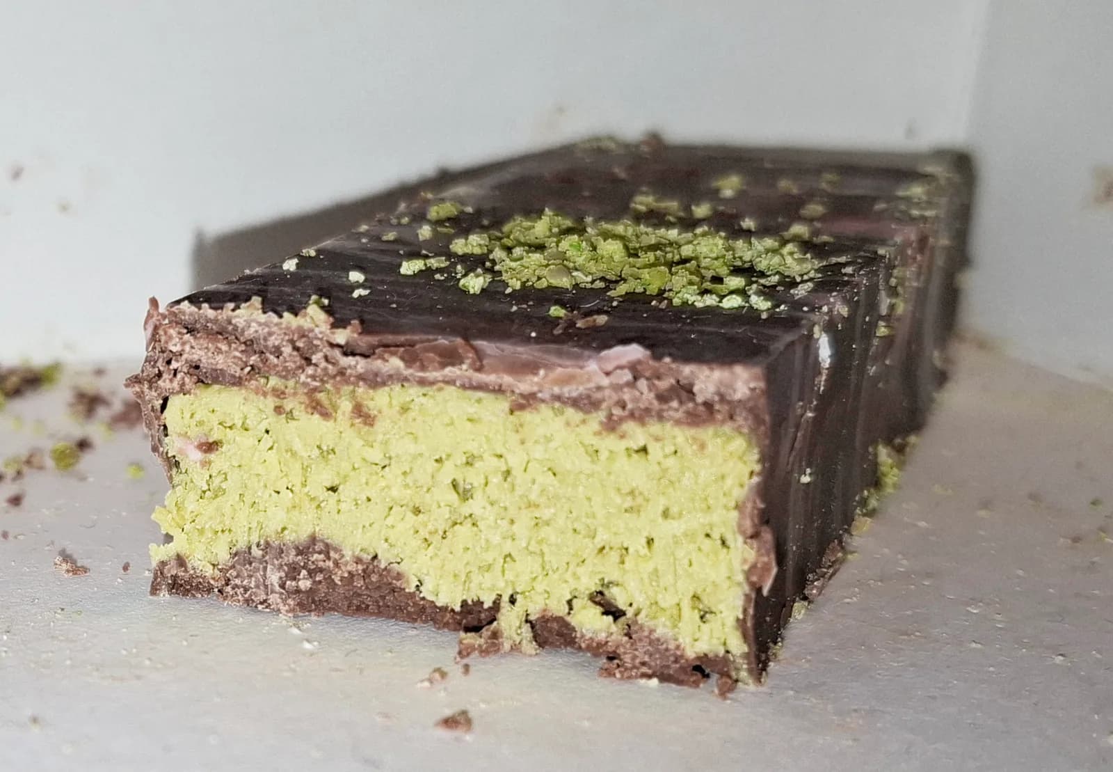 A Dubai chocolate bar cut through to show the pistachio and kataifi filling