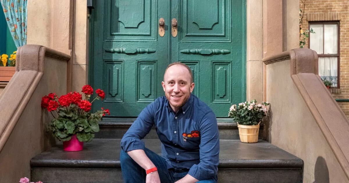 Aaron Bisman on the stoop pf 123 Sesame Street.