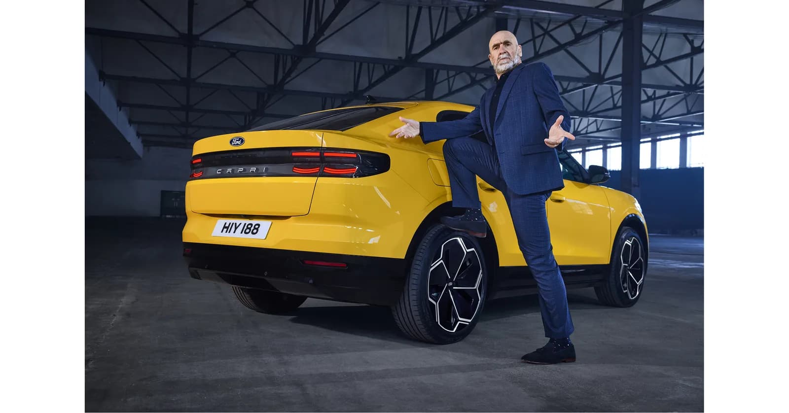 Official Ford photographs of Cantona with the yellow electric Capri.