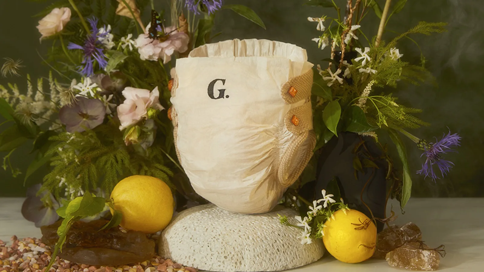 Mother’s campaign photograph shows The Diapér on a pedestal with flowers and lemons.