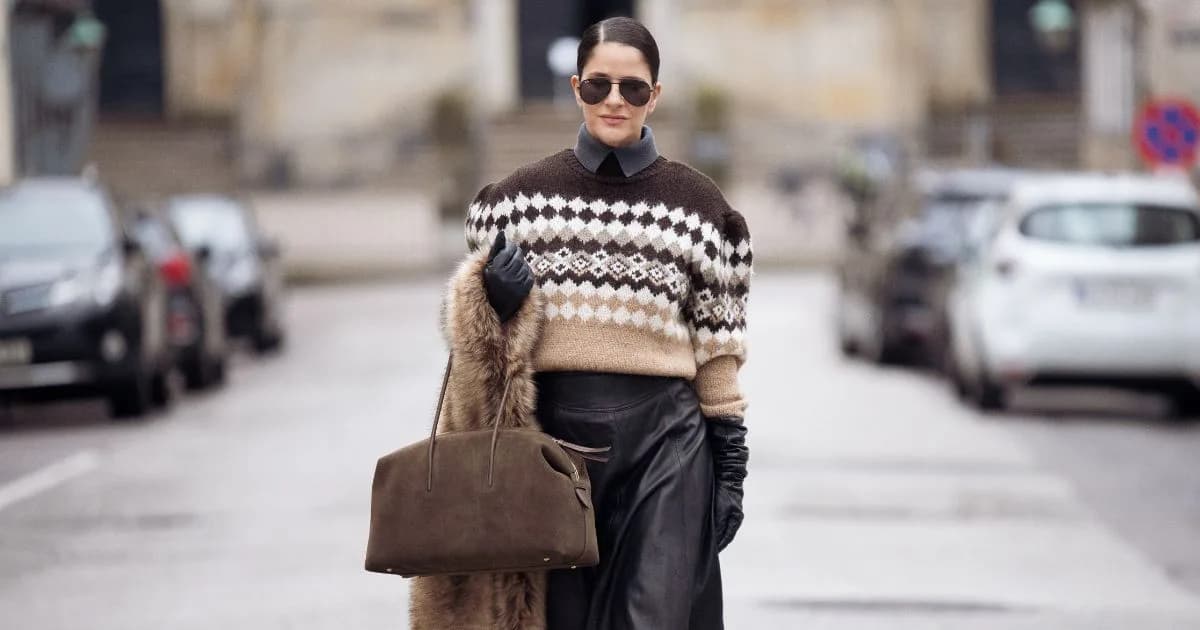 Woman in brown knit jumper with suede bag