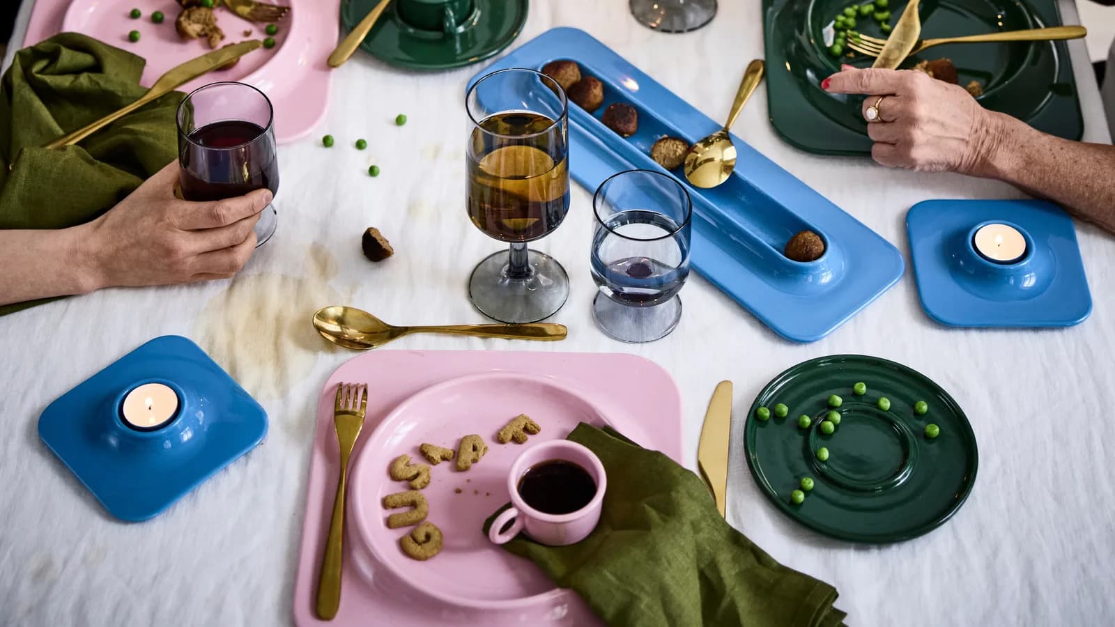 IKEA X Gustaf Westman collection on a busy dining table.
