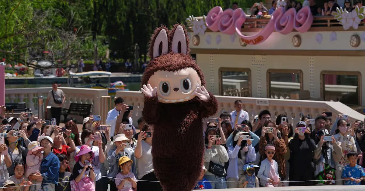 A Labubu mascot performs for visitors to Pop Land, a theme park for Pop Mart, manufacturer of collectible toys and plush dolls during the May Day holiday in Beijing, Thursday, May 1, 2025. (AP…