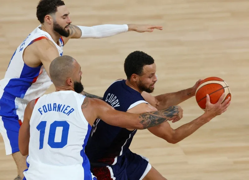 U.S. player Stephen Curry plays against Evan Fournier of France and Isaia Cordinier of France Aug. 10 in Paris, France. McDonald's France humorously posted on social media about ending its curry…