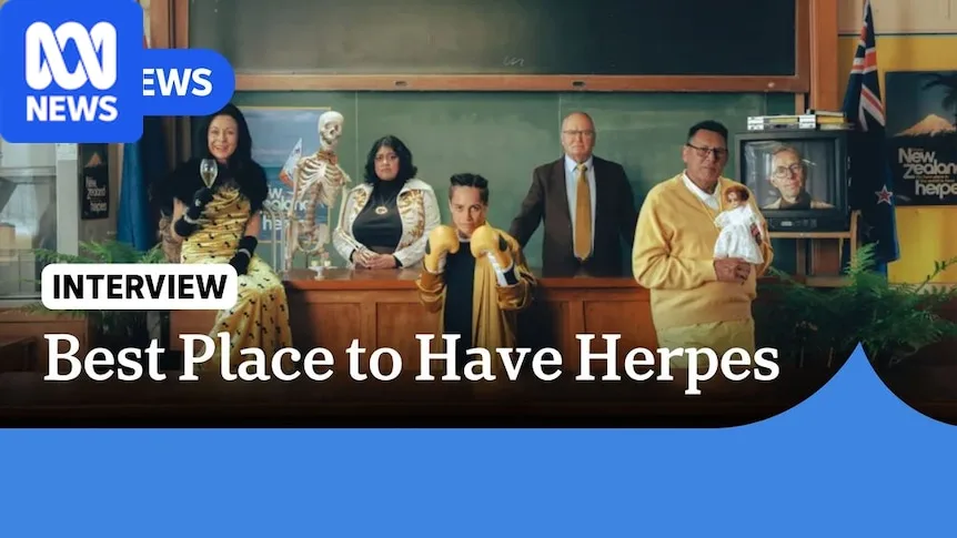 Best Place to Have Herpes: People wearing black and gold in a classroom looking at the camera.