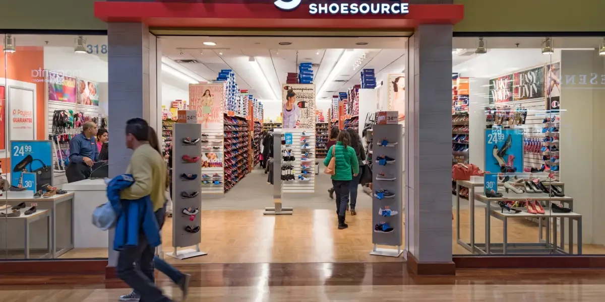 Payless Shoe Store, Couple walking in a mall corridor