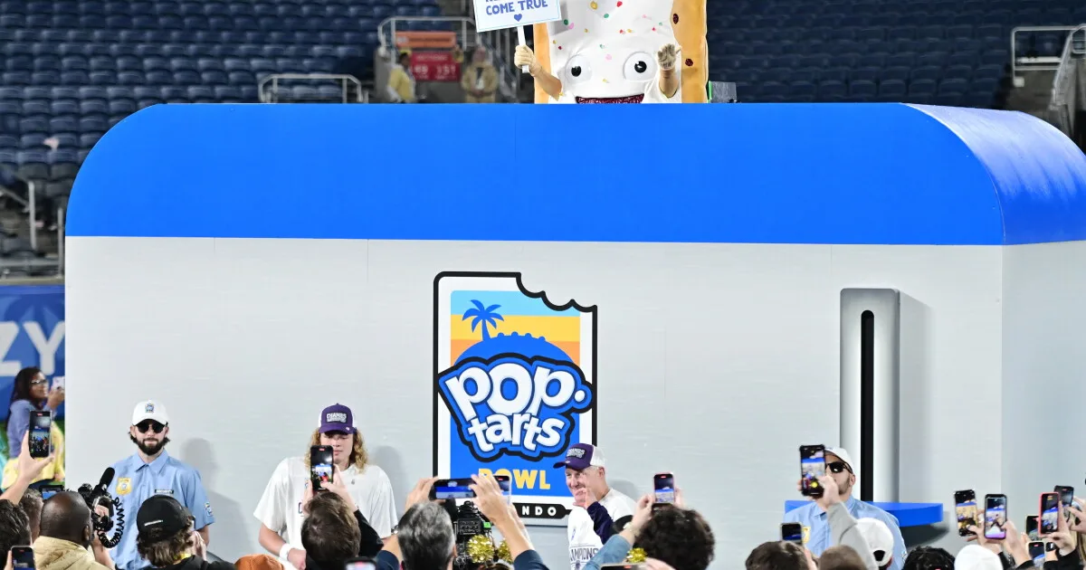 The Pop-Tarts mascot is lowered into a toaster following the 2023 Pop-Tarts Bowl between the Kansas State Wildcats and the NC State Wolfpack at Camping World Stadium on Thursday in Orlando, Fla.