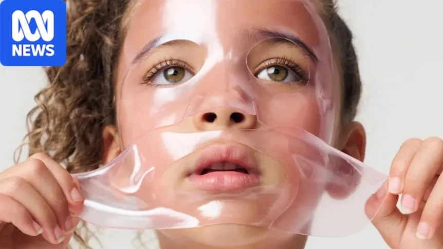 A young girl placing a pink-coloured, gel sheet mask over her face
