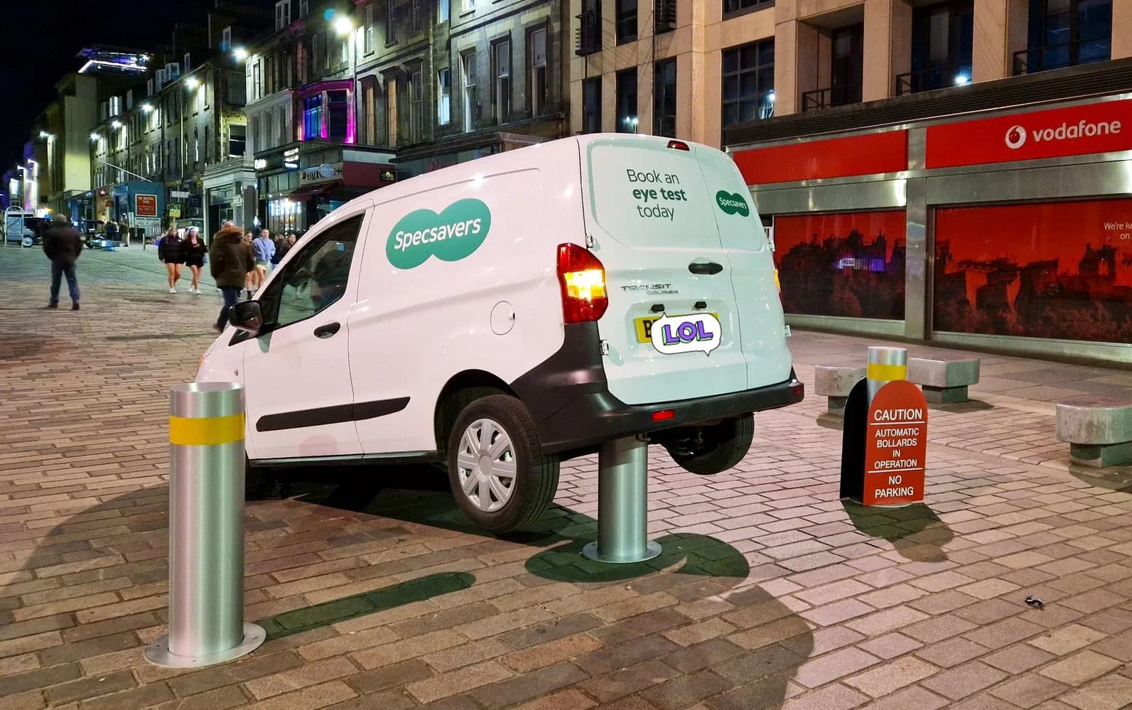 A Specsavers van sits on top of a rising bollard. Yes, really.