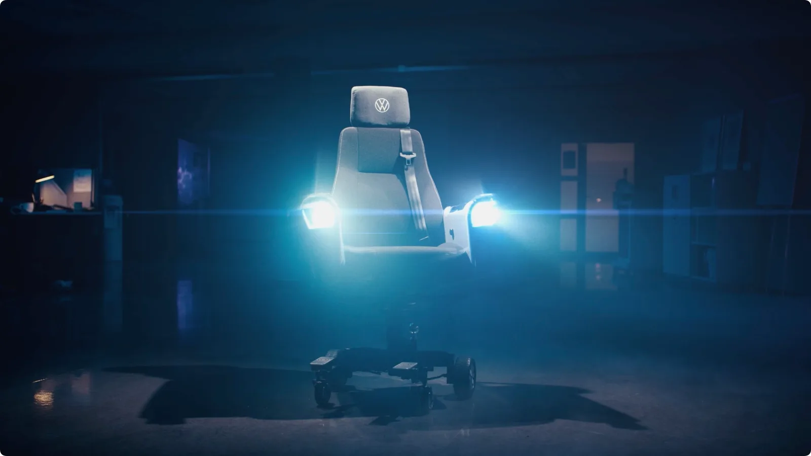 The Volkswagen electric office chair with its headlights illuminated.