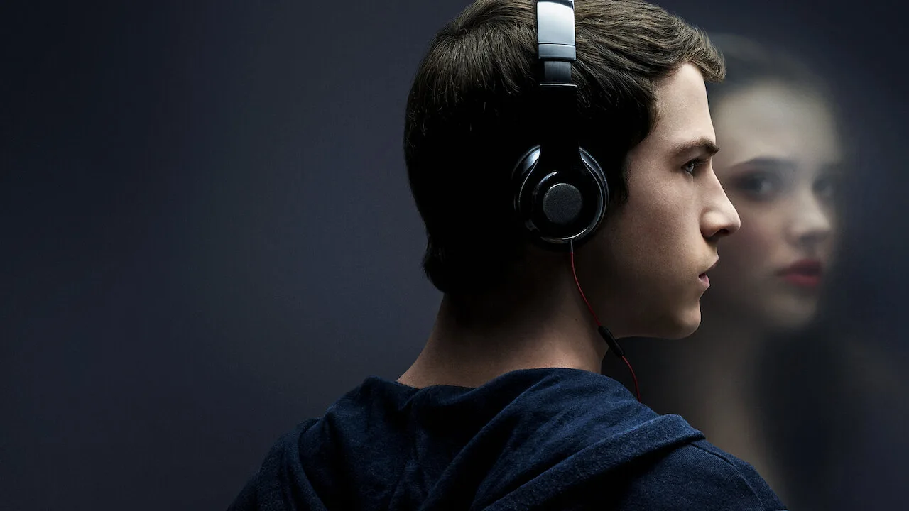 First-season Netflix key art showing Clay wearing headphones with Hannah behind him.