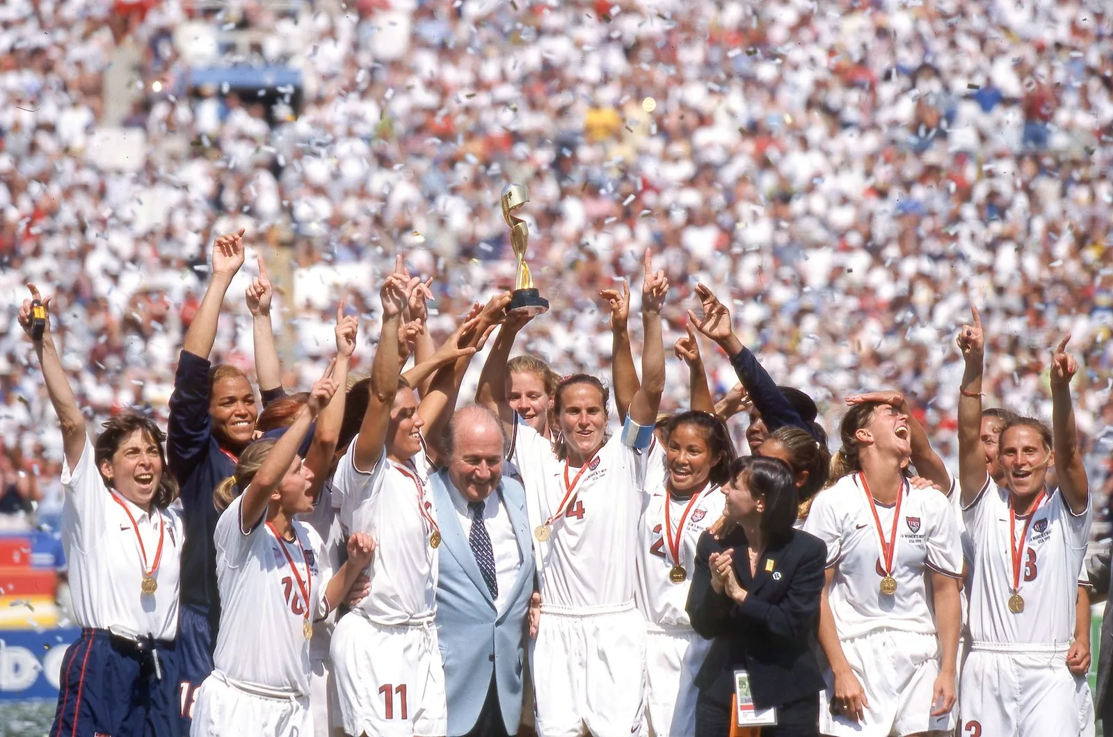 The 1999 US women's team lifting the World Cup trophy at the Rose Bowl