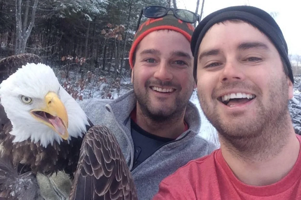 Canadian brothers free trapped bald eagle, take selfie with it