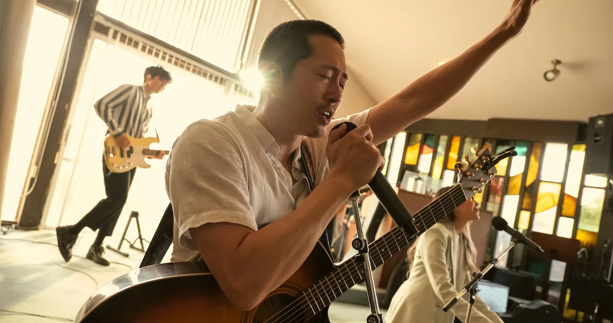 Steven Yeun as Danny Cho singing in church.