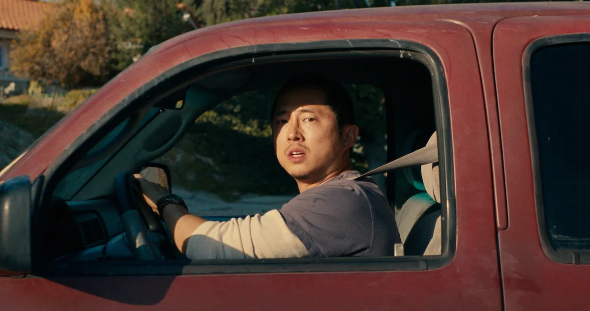 Steven Yeun as Danny in his pickup truck.