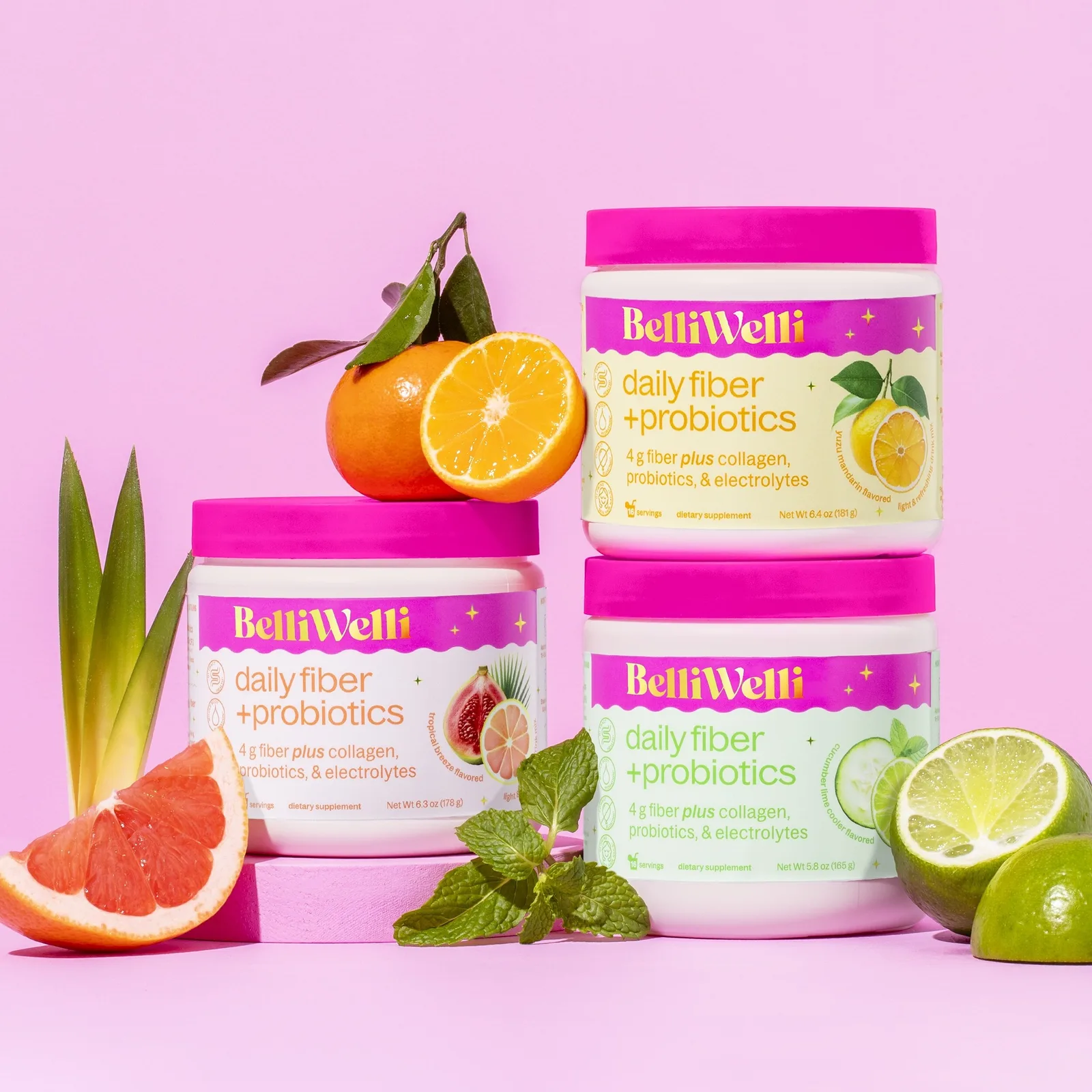 BelliWelli powder tubs in the three Walmart launch flavors, with pink lids and fruit.