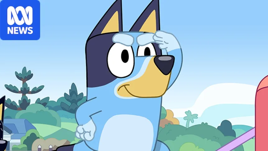 A young animated Blue Heeler stands atop playground equipment and surveys the land, three other animated dogs play behind him.
