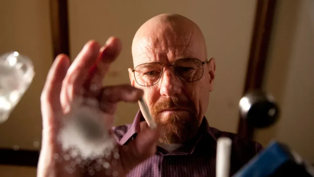 Walter White holds up a blue crystal