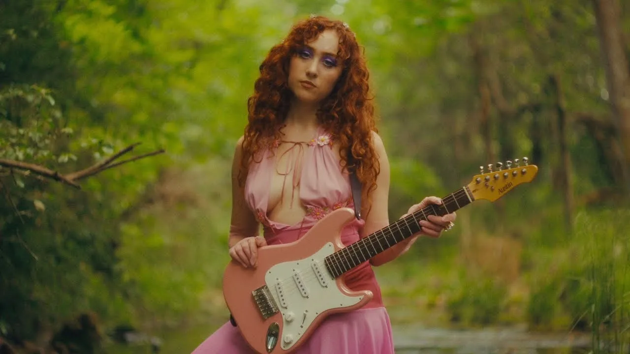 Chappell Roan with a guitar in the album video