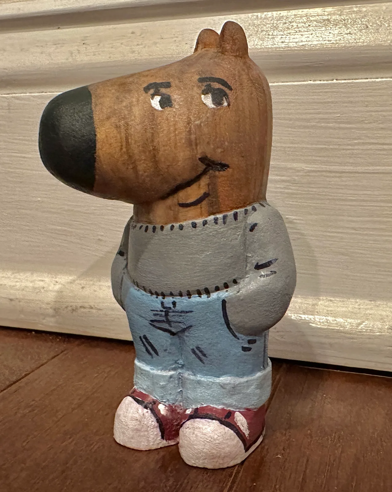 A painted wood carving of Chill Guy, photographed in December 2024. The photograph is dedicated under CC0.