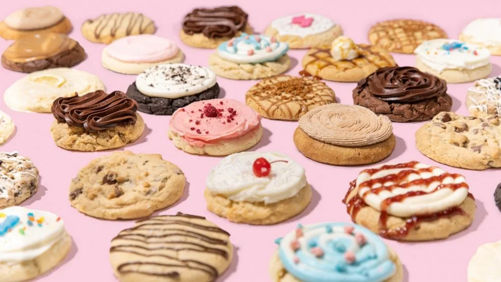 Assorted Crumbl cookies with pink and pastel frostings.