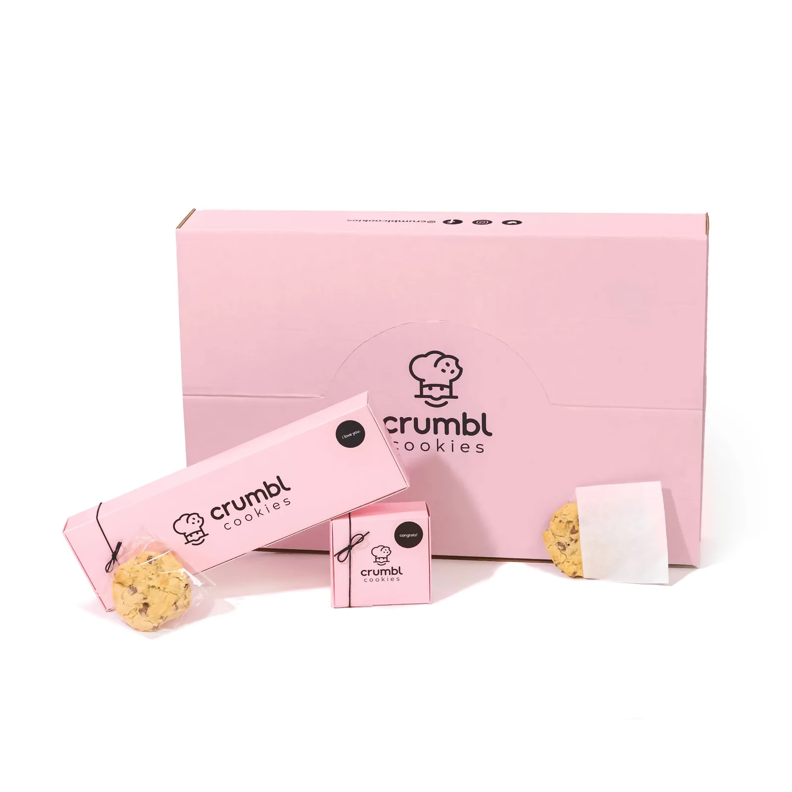 Crumbl's pink boxes in several sizes.