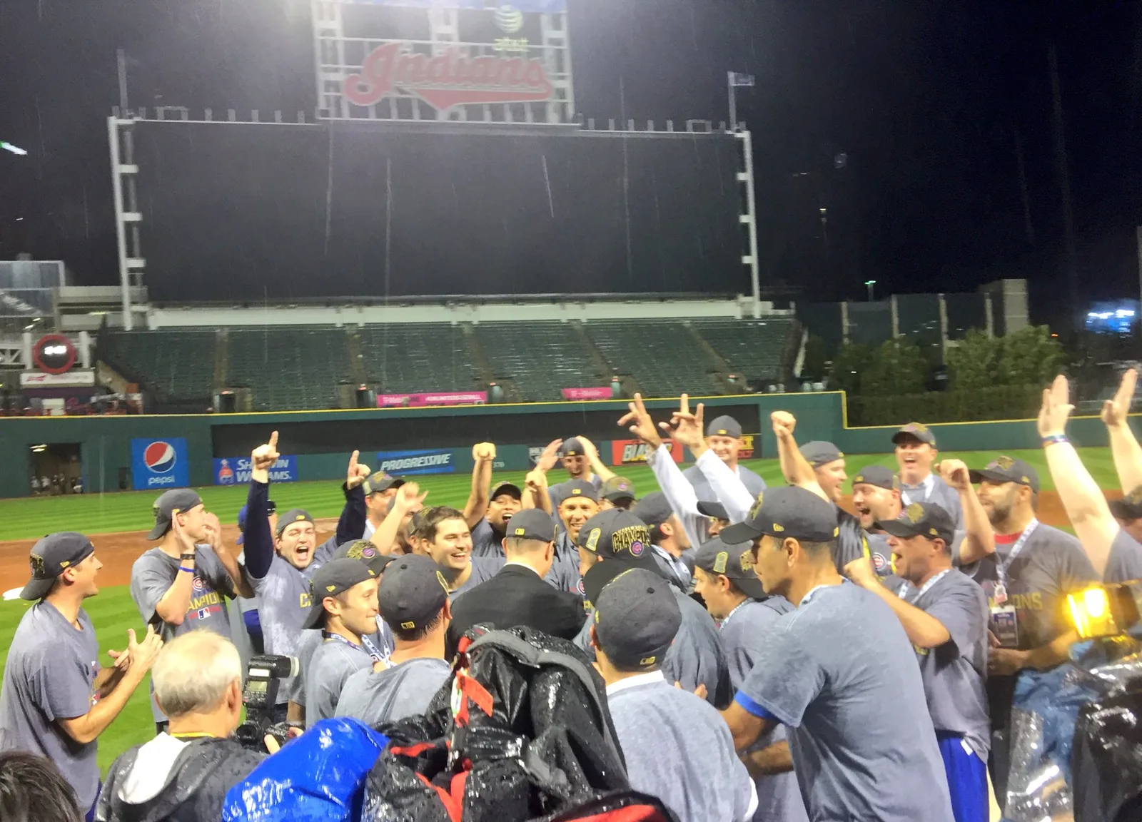 The Cubs team gathers for a photo on the field after the win