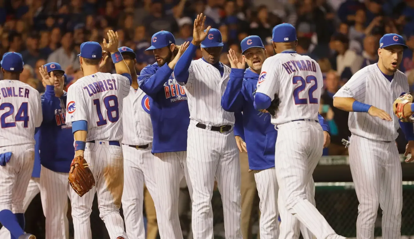 Cubs players embrace on the field after Game 7