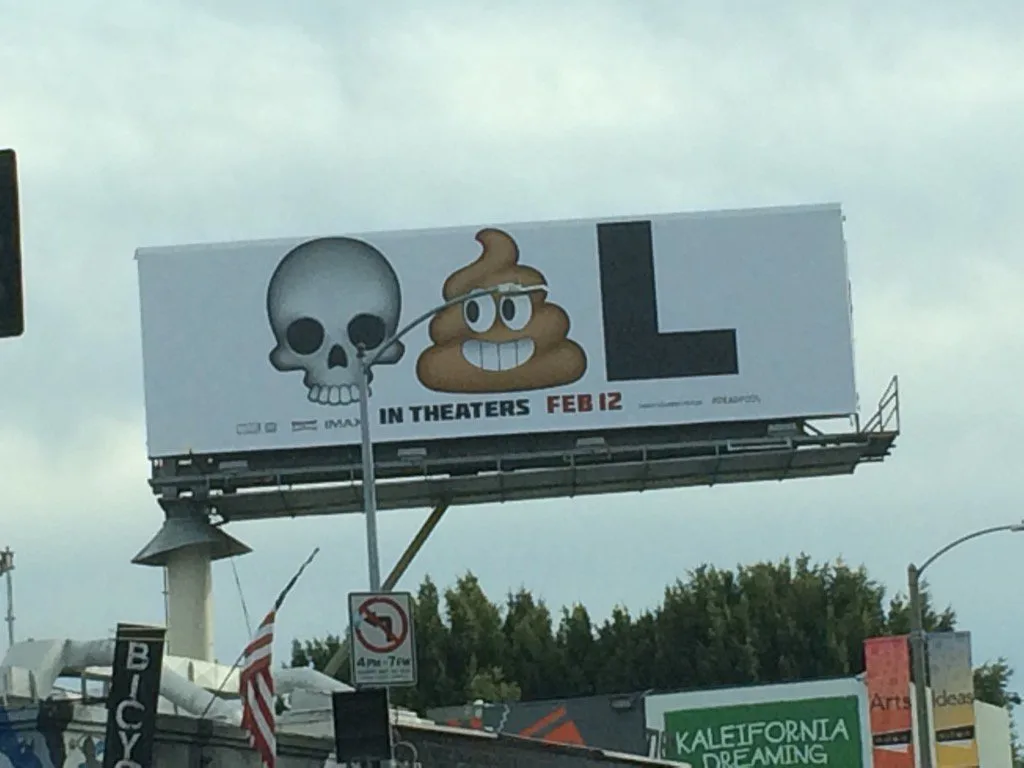 The skull, poop and L emoji billboard on a street
