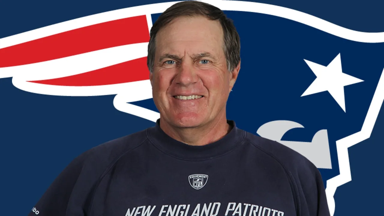 Bill Belichick in front of a Patriots logo backdrop