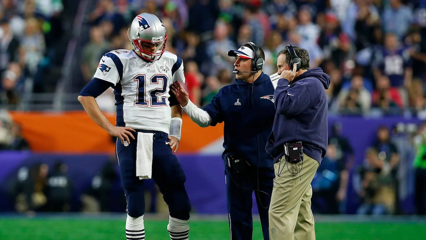 Tom Brady talking with coaches on the Patriots sideline