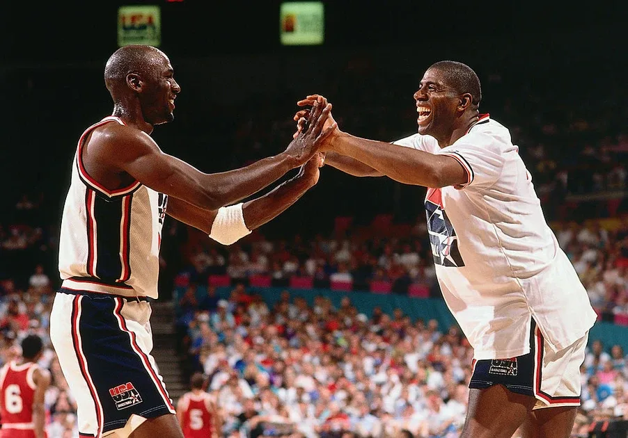 Michael Jordan and Magic Johnson slap hands on court