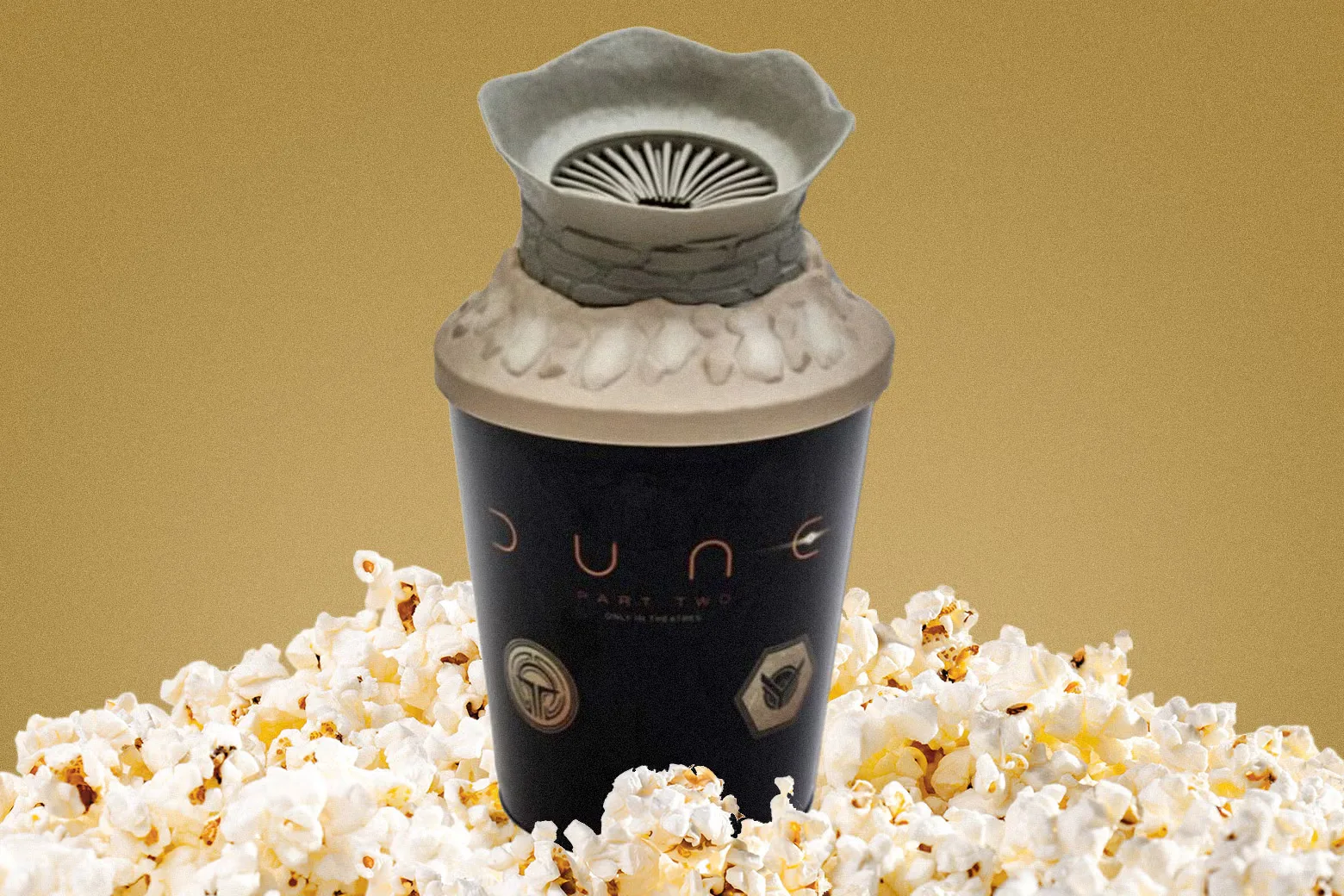 The sandworm popcorn bucket on a bed of popcorn.