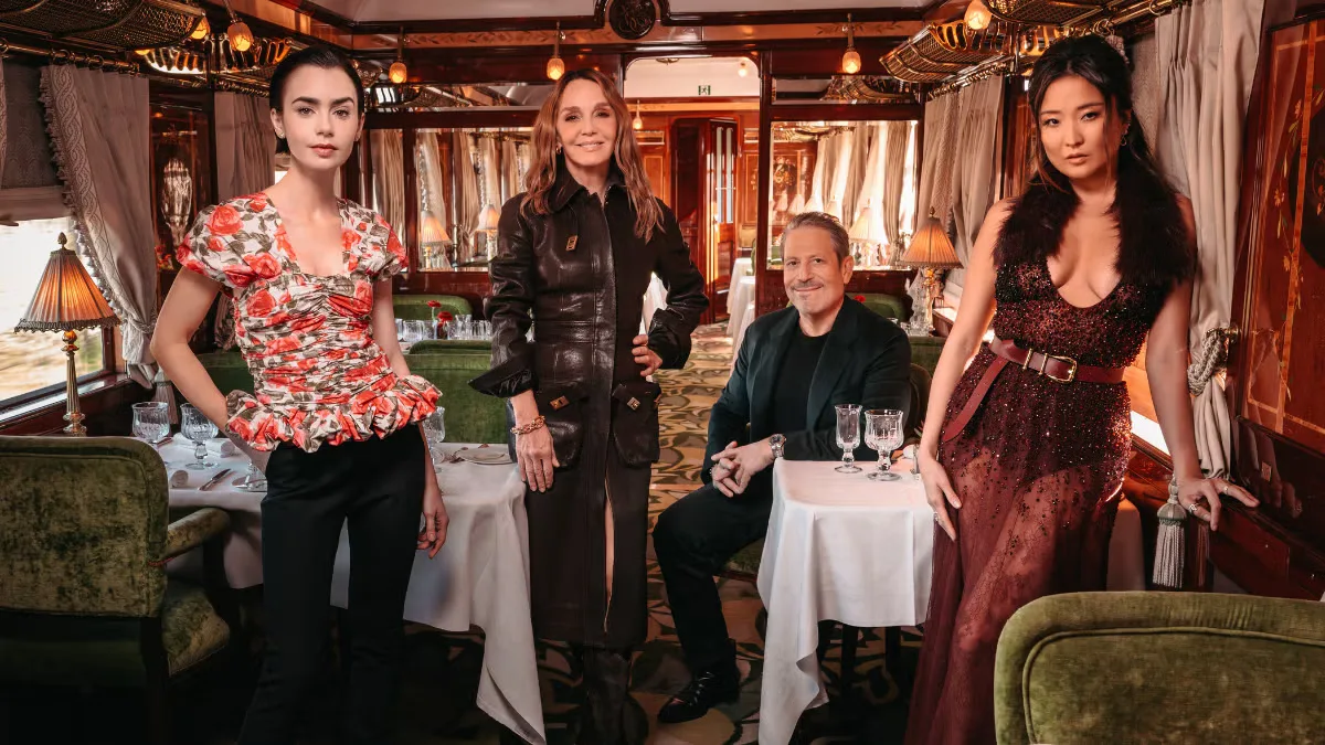 The Emily in Paris cast at a restaurant table.