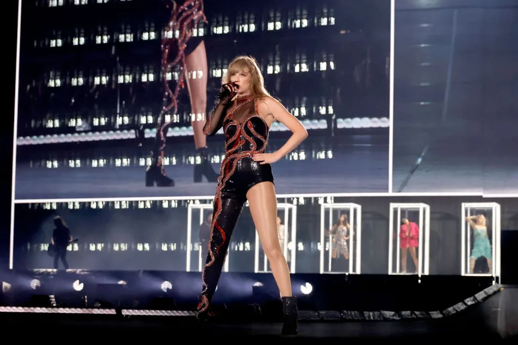 Taylor Swift performing on a lit stage