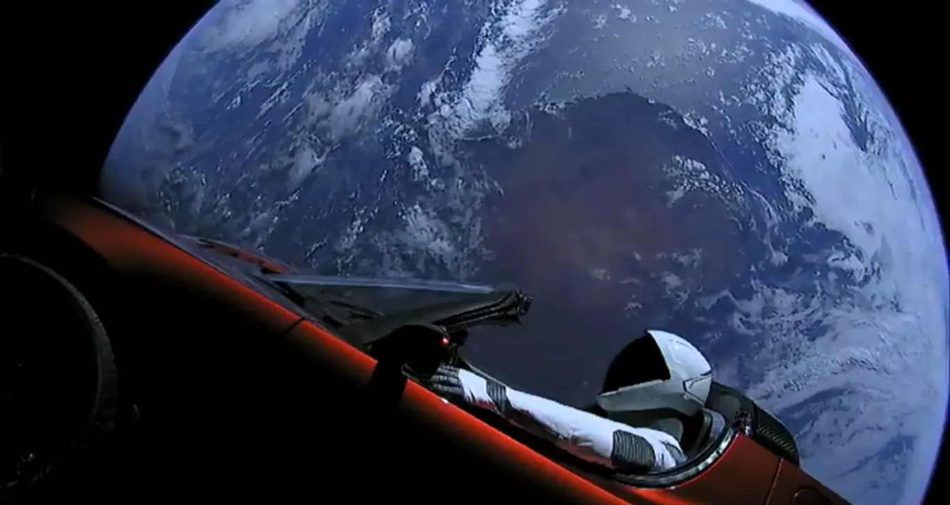 SpaceX's Starman mannequin is seen inside Elon Musk's red Tesla Roadster in space, with the brilliant Earth in frame, in this jaw-dropping view from a camera on the car. SpaceX launched the…