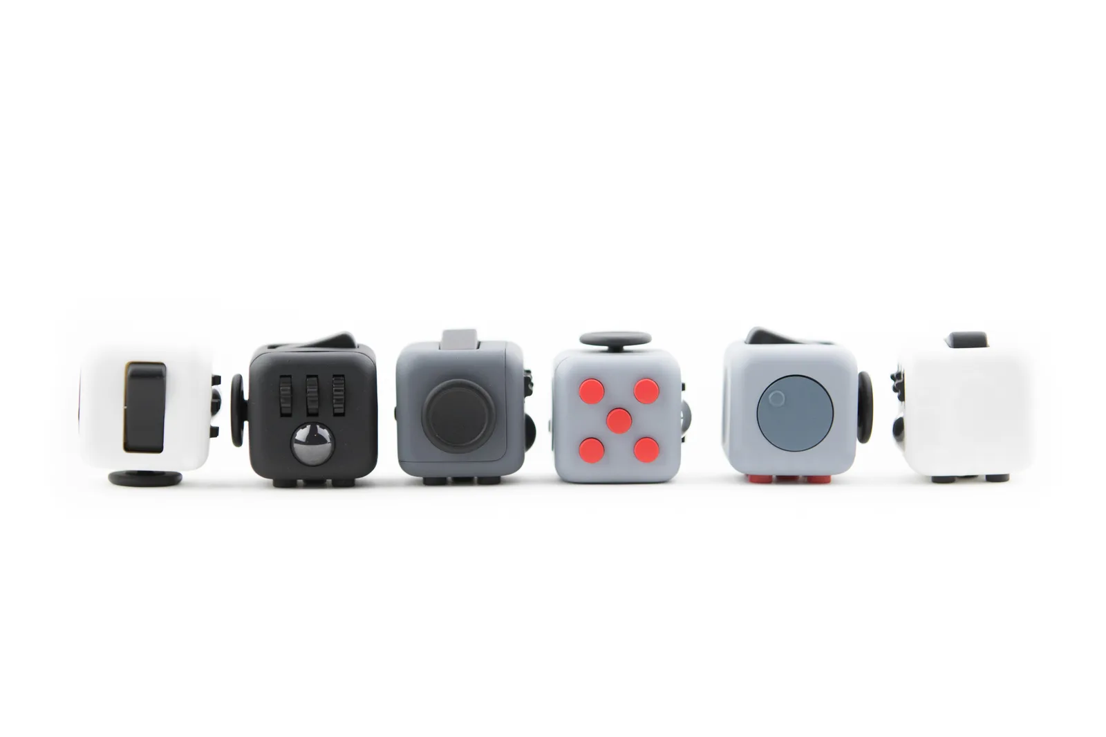 Original press photograph showing all six Fidget Cube faces; Commons records unrestricted reuse.