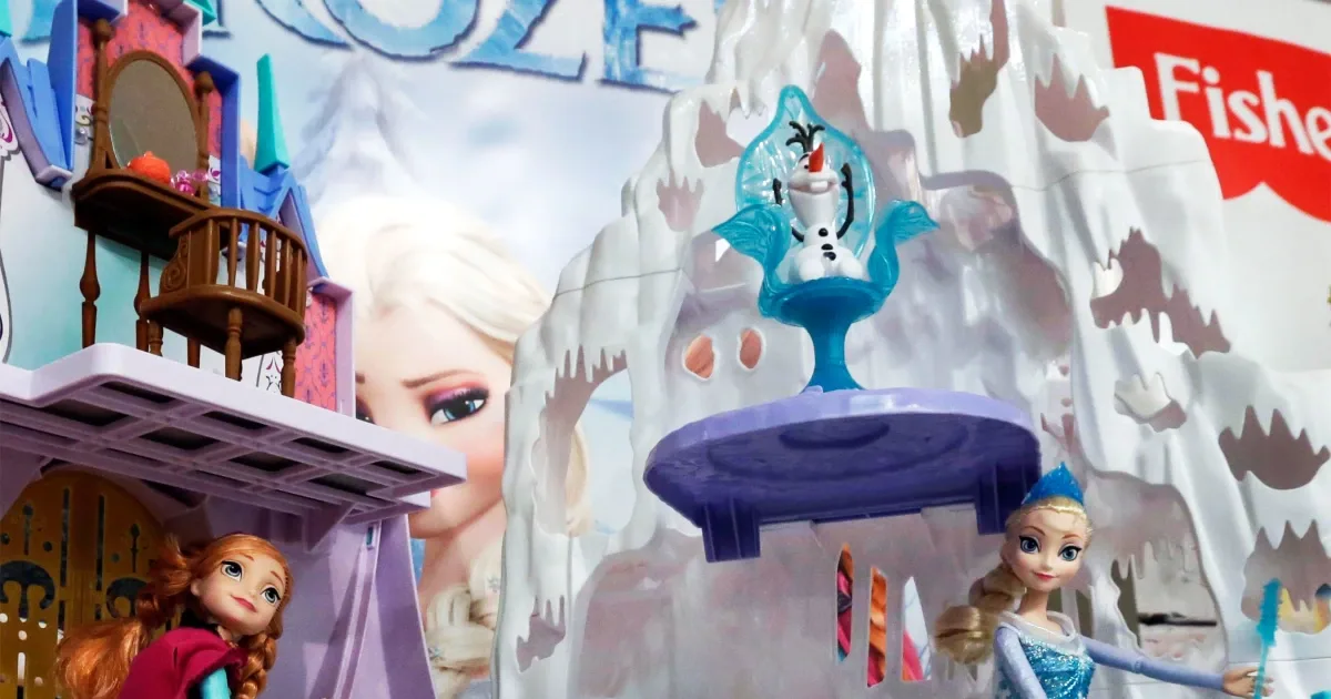 Frozen ice-castle playset and dolls on a toy display.