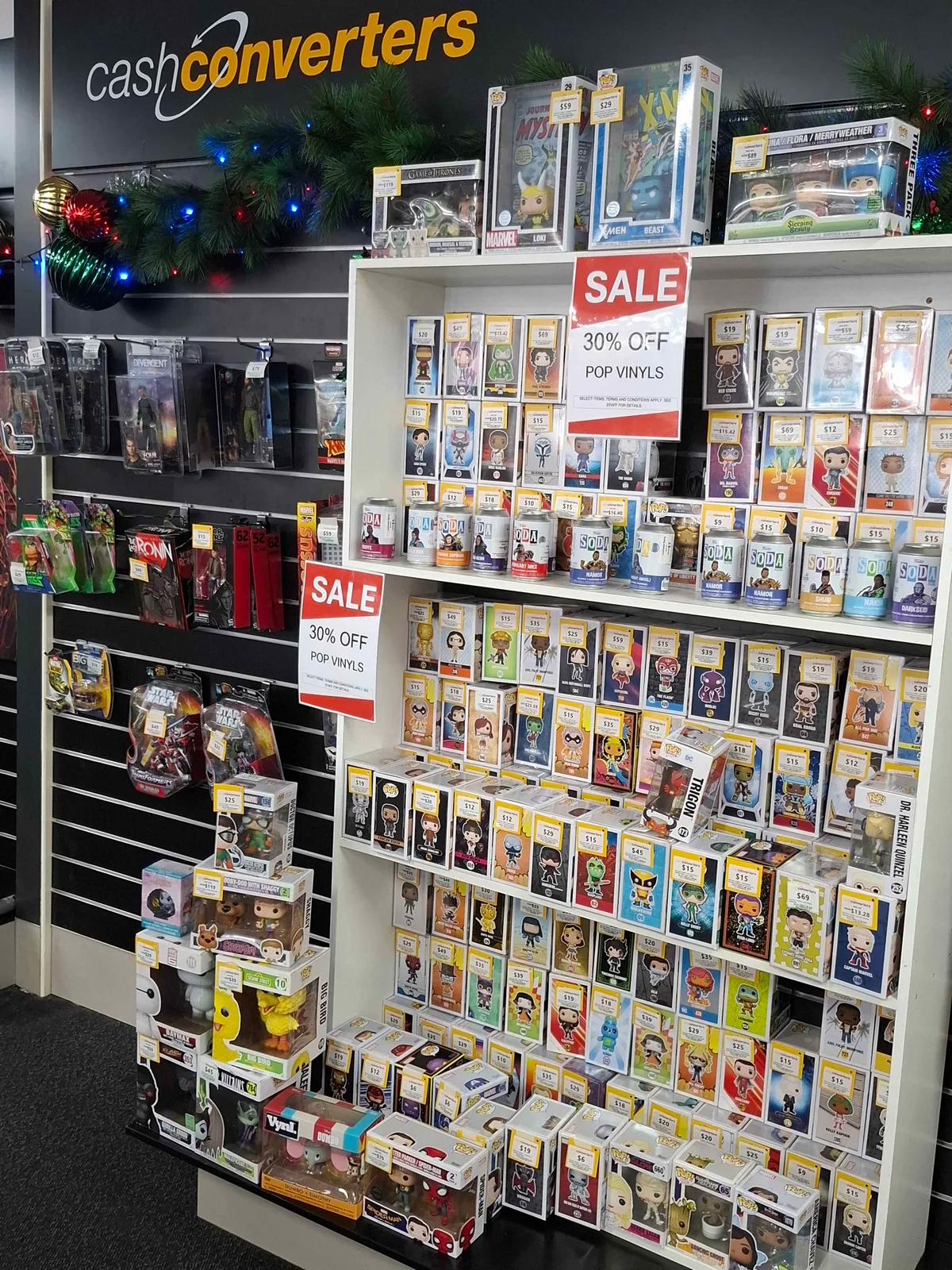 A wall of Pop! figures on a resale shop shelf