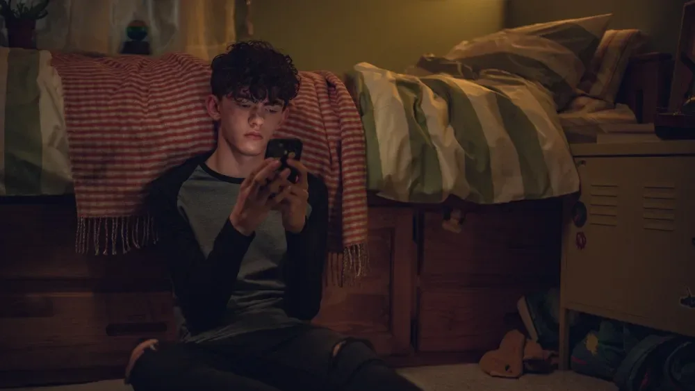 Charlie in his bedroom in a scene from Heartstopper.