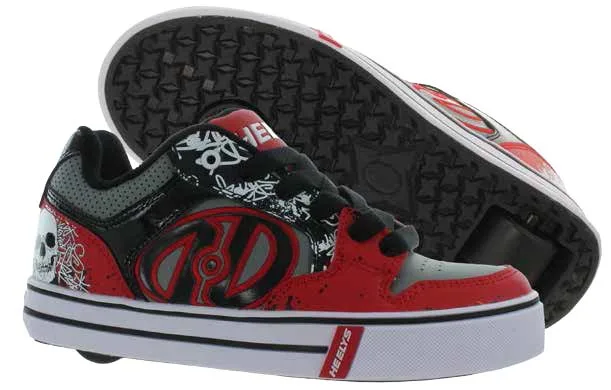 A pair of red, black and grey Heelys, including an upturned shoe showing its sole.