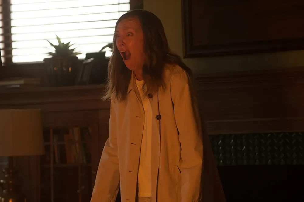 A dimly lit scene from Hereditary.