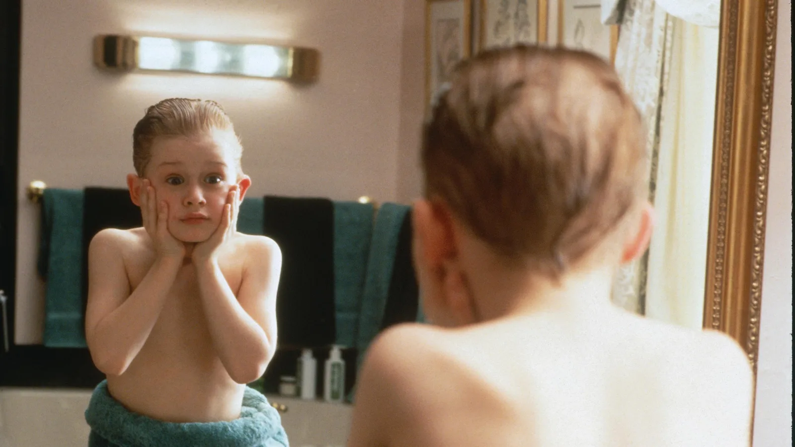 Kevin slaps on aftershave and screams in the bathroom mirror