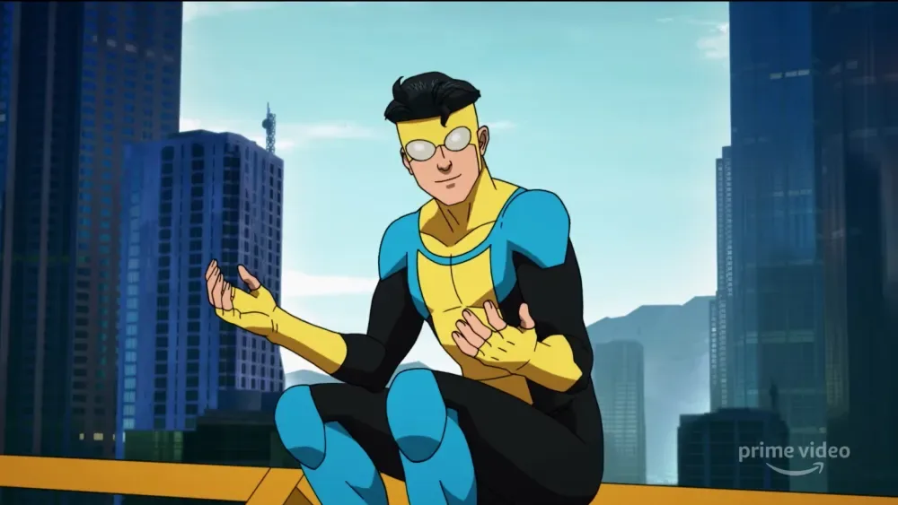 Invincible sitting on a rooftop above the city.