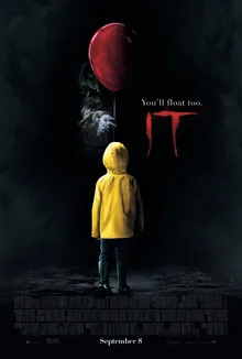 It (2017) poster: Georgie in a yellow raincoat with a red balloon.